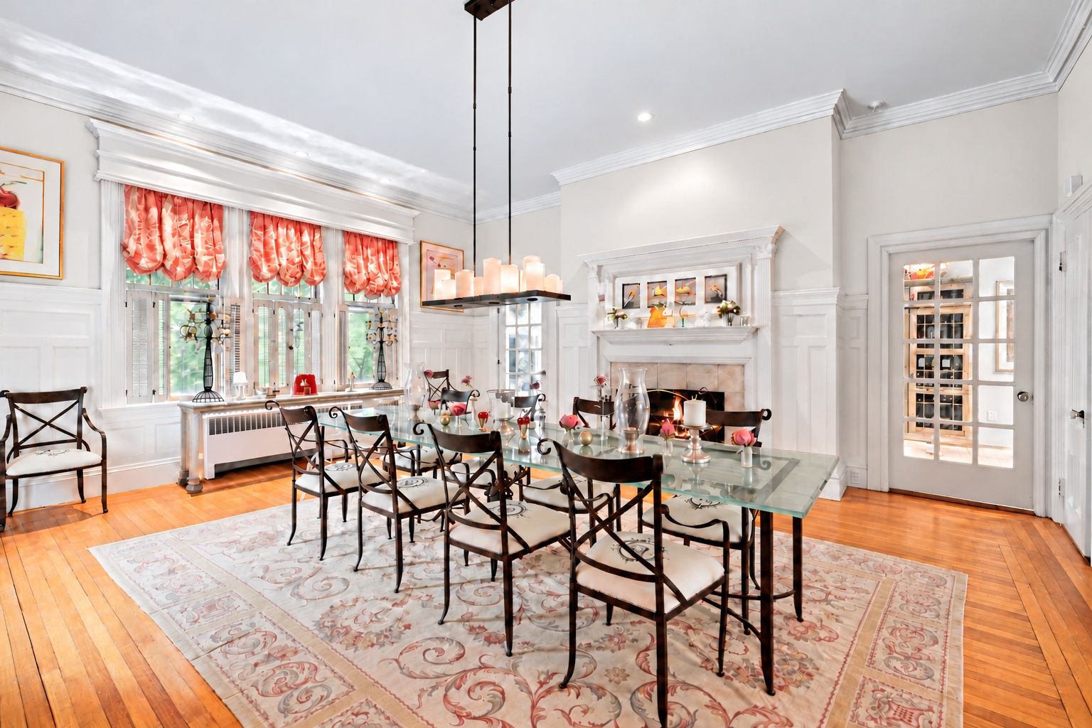 Bright dining room with light walls, artwork, and a glass dining table