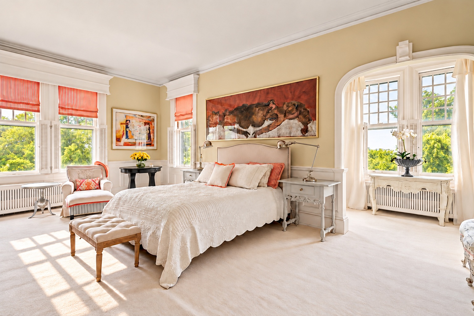 Sunlit principal bedroom with a large painting above the bed